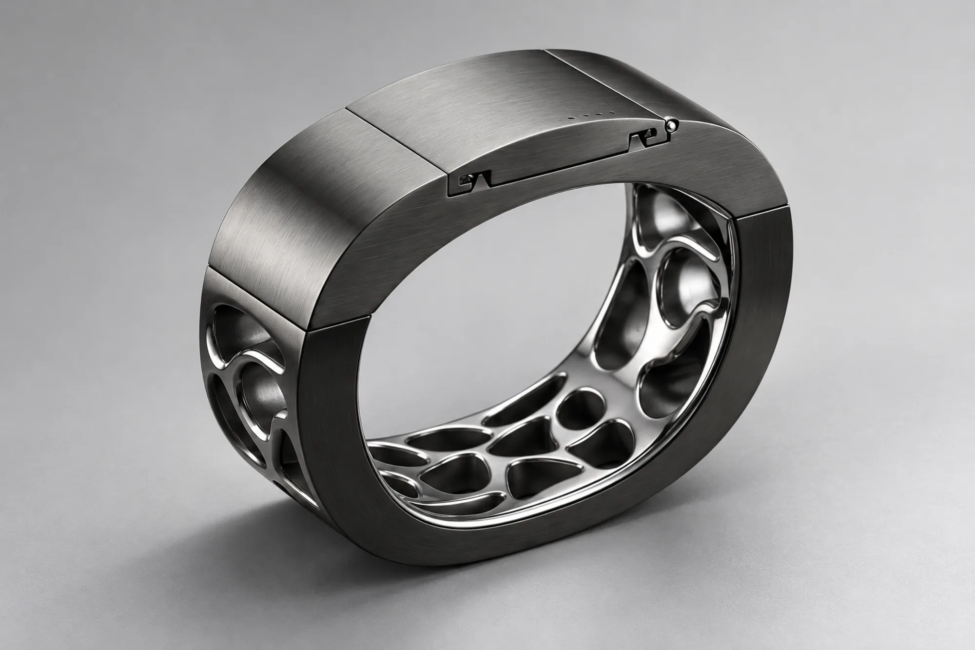 AI-assisted render based on the original design — Three-quarter studio view of the brushed gunmetal SILLAGE bangle with its hinged top panel and polished lattice interior on a seamless light-grey backdrop.